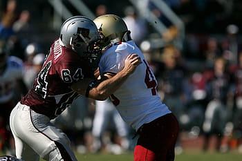 american football, people sport, football players, sports action, football game, athletic competition, sports field, team sports, football uniforms, sports helmet, physical activity
